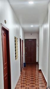 a hallway with a door and a tile floor at TANJIL RESTAURANT & Guesthouse in Phnom Penh