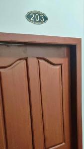a wooden door with a sign on top of it at TANJIL RESTAURANT & Guesthouse in Phnom Penh +6 photos