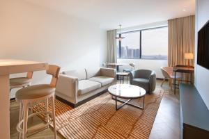 a living room with a couch and a table at Radisson Blu Residence, Dubai Marina in Dubai