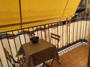 a table and chairs on a balcony at Heidi's home in Villabate +7 photos