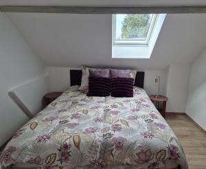 a bed in a small room with a window at le St fursy 31 in Péronne