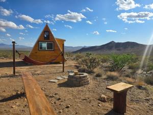 a tiny house in the middle of the desert at Starwalk Modern A-Frame #1 in Meadview