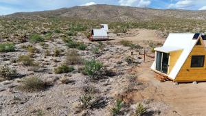an aerial view of a tiny house in the desert at Starwalk Modern A-Frame #1 in Meadview +19 photos