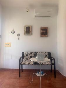 a couch with a laptop on a table in a room at Casa Malò 2 in Ovile la Marinella