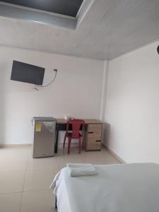 a room with a desk and a table and a red chair at Hotel don Nilo in Albania