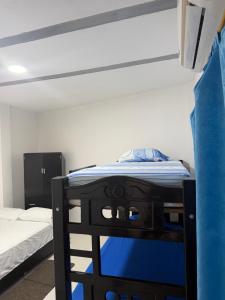 a bedroom with a bunk bed with a blue mattress at Hotel don Nilo in Albania