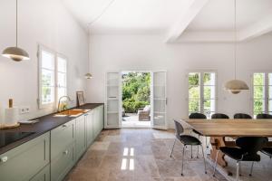 a kitchen with a table and chairs and a dining room at House on the Hill in Nice