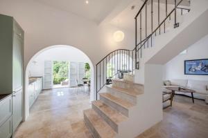 an arched hallway with a staircase in a home at House on the Hill in Nice
