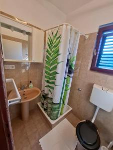 a bathroom with a sink and a shower curtain at Marija šimičić in Rab +37 photos