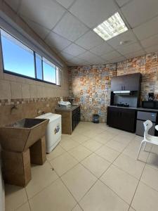 a large kitchen with a sink in a room at Apartamentos Marconela in San Mateo