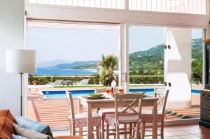 a dining room with a view of the ocean at Simpson Secret - Epirus Coast in Ligia