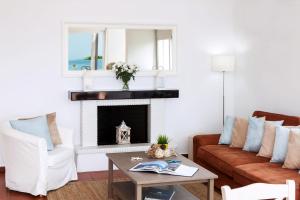 a living room with a couch and a fireplace at Simpson Secret - Epirus Coast in Ligia