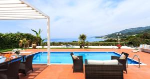 a villa with a swimming pool and a patio at Simpson Secret - Epirus Coast in Ligia
