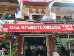 a sign for a restaurant and guest house on a building at TANJIL RESTAURANT & Guesthouse in Phnom Penh