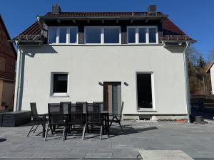 a group of chairs sitting in front of a house at Ferienhaus Hirschi in Eisenach