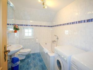 a bathroom with a sink and a washing machine in it at Villa Lisa in Glowe +23 photos