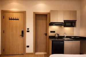 a small kitchen with a sink and a door at Cairo Stays Hotel in Cairo