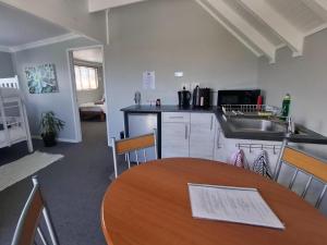a kitchen with a table and a counter top at Gables B&B Guesthouse in George +16 photos