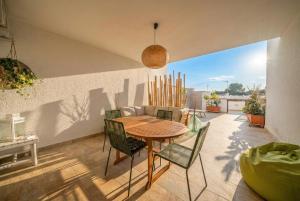 a dining room with a table and chairs on a patio at La Dimora del Sole in Monopoli