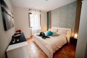 a bedroom with a bed with a pair of shoes on it at Aura Apartment - VISTA LAGO - CENTRO STORICO in Bracciano