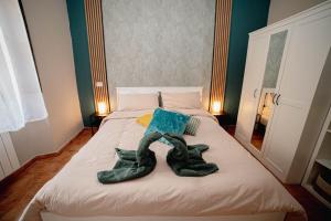 a bed with two pairs of shoes on it at Aura Apartment - VISTA LAGO - CENTRO STORICO in Bracciano