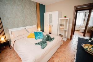 a bedroom with a bed with a stuffed animal on it at Aura Apartment - VISTA LAGO - CENTRO STORICO in Bracciano