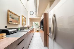 a kitchen with a sink and a refrigerator at Large fully renovated 250m house in Nantes