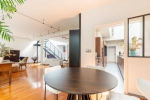 a dining room and living room with a table and chairs at Large fully renovated 250m house in Nantes
