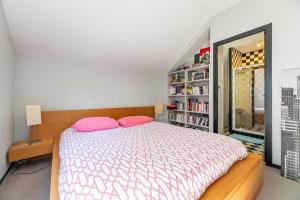 a bedroom with a bed and a book shelf at Large fully renovated 250m house in Nantes +6 photos
