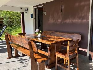 a wooden table with two wooden chairs and a wooden table and bench at Fethy`s House in Brod na Kupi +52 photos