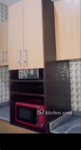 a kitchen with a microwave and a counter top at Living Space Home in Lekki +20 photos