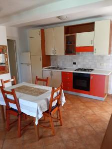 a kitchen with a table and chairs and a stove at Palm Beach Resort in Boca Chica
