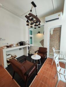a living room with chairs and a table at R4R RoomforRest Boutique Hotel Bangsaen Beach in Ban Laem Thaen