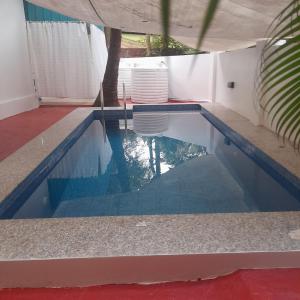 a swimming pool in a house with a pool at BaywoodGoa -200 meters from Morjim Beach in Morjim +35 photos