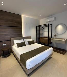 a bedroom with a large bed and a sink at Stegna Sea & Sun in Archangelos