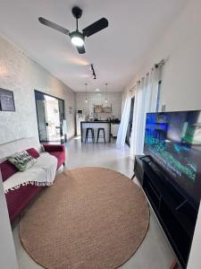 a living room with a large flat screen tv at Casa 2min do Centro & Piscina in Bonito