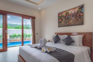 a bedroom with two beds and a large window at Villa Chandra Lovina in Lovina +35 photos