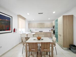 a kitchen with a table and chairs in a room at Good Times in Sliema