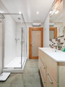 a bathroom with a shower and a sink and a tub at Good Times in Sliema +20 photos