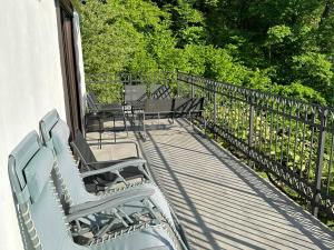a porch with benches and tables and a fence at Fethy`s House in Brod na Kupi