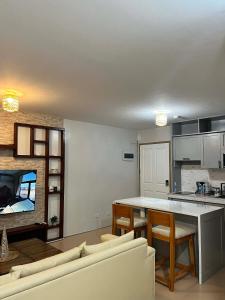 a kitchen and living room with a couch and a table at The Lotus Suite2 Iloilo in Iloilo City