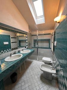 a bathroom with two sinks and two toilets at Casa di Giò - Comfy Lake Como Attic in Malgrate +19 photos