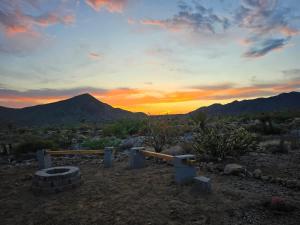 a sunset in the desert with a mountain in the background at Star Gazer #3 Glamping in Meadview