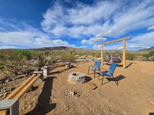 two chairs and a swing in the desert at Star Gazer #3 Glamping in Meadview +38 photos