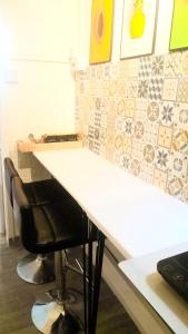 a white counter with a black chair at a desk at Central Simple Cambridge stay in Cambridge +4 photos