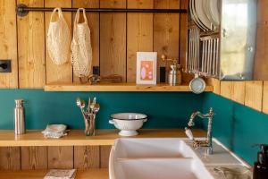 a kitchen with a sink and a wooden wall at Bon Air Club in Saint-Léonard-des-Bois +67 photos