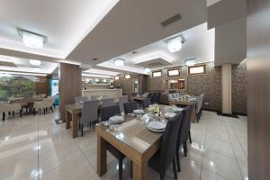 a dining room with a table and chairs at Hotel Villa Pace in Međugorje
