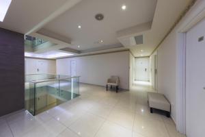 an empty room with a glass desk and chairs at Hotel Villa Pace in Međugorje
