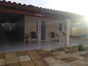a house with two chairs on a patio at Casa do Descanso in Triunfo