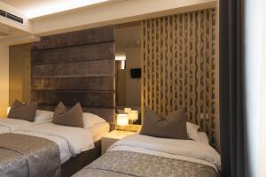 a hotel room with two beds and a mirror at Hotel Villa Pace in Međugorje +129 photos